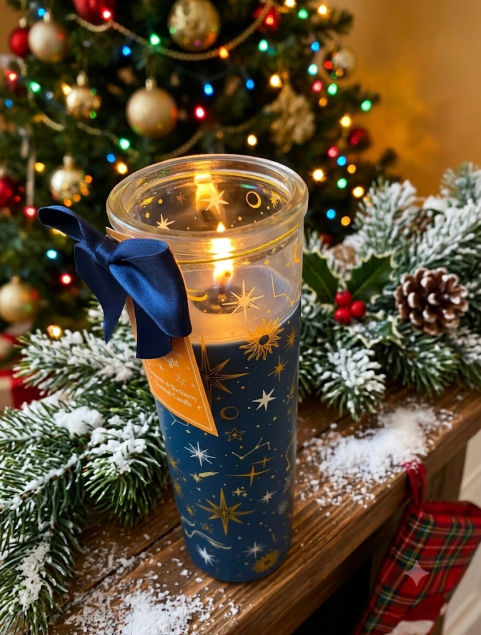 Cinnamon and Blackberry Christmas tube candle lit with navy star constellation design glowing