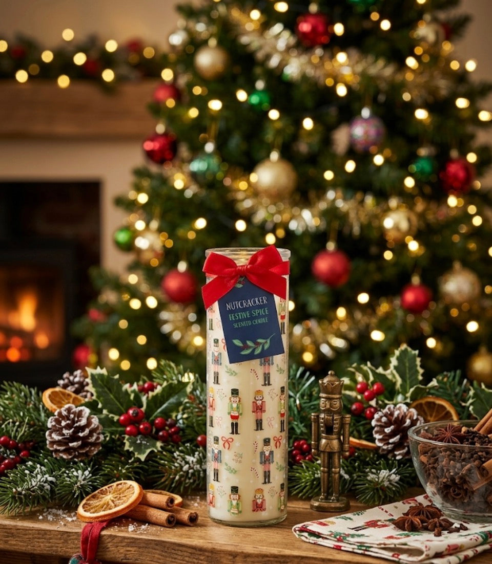 Nutcracker Festive Spice Christmas tube candle unlit showing full nutcracker and candy cane design with red bow